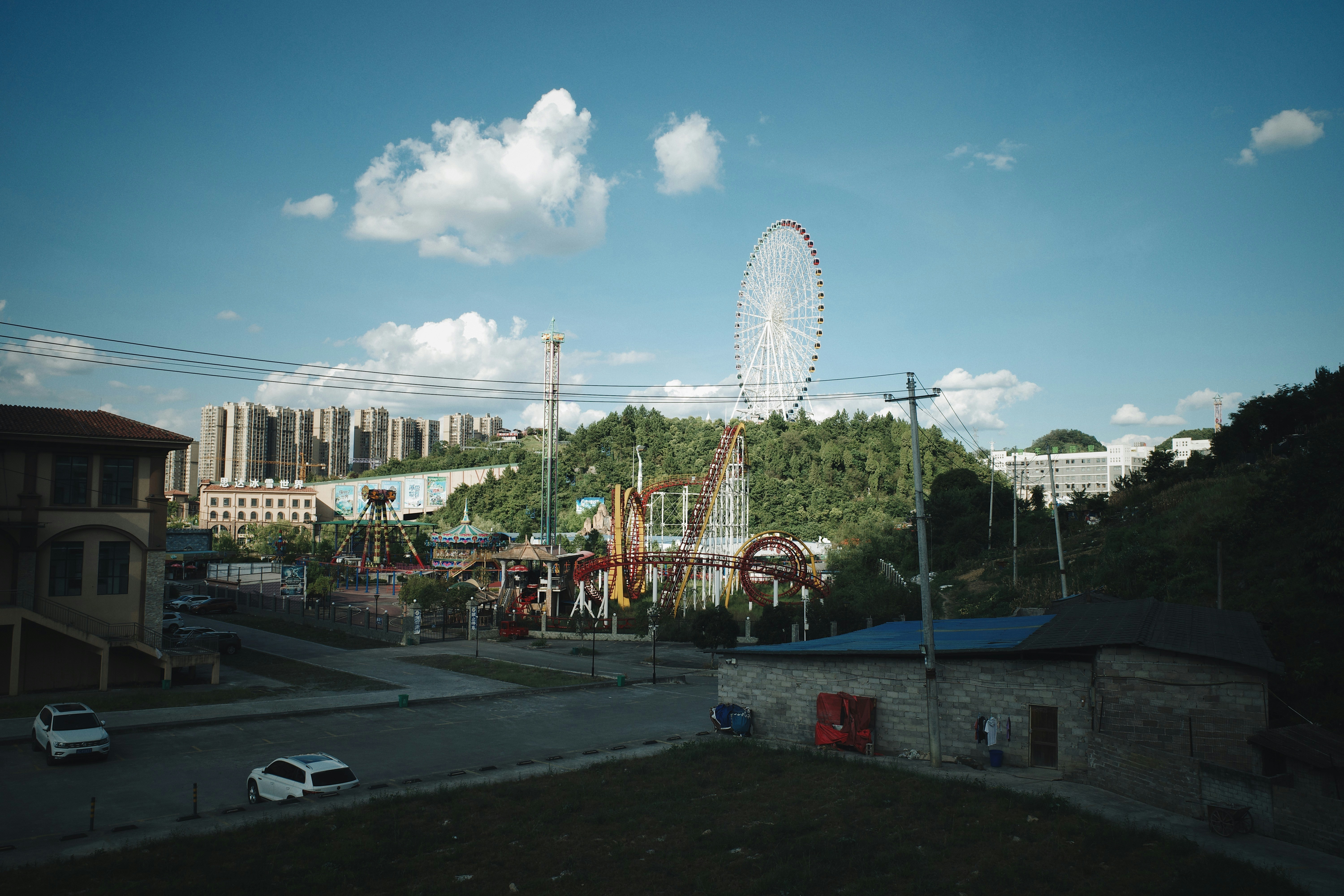 an amusement park with a ferris wheel in the background