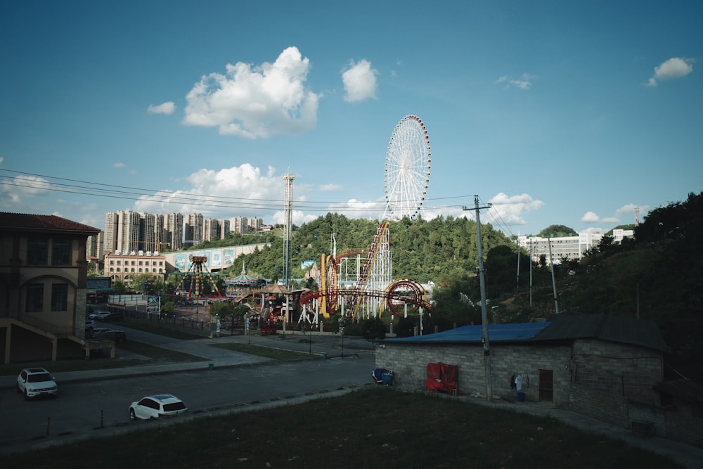 an amusement park with a ferris wheel in the background