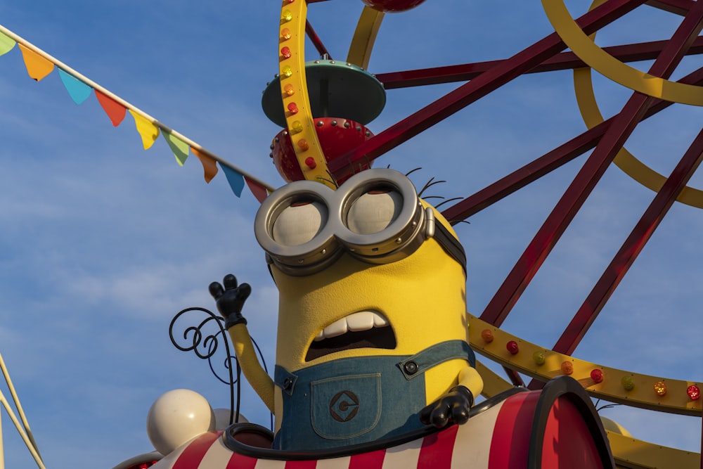 a minion rides a carnival ride at a carnival