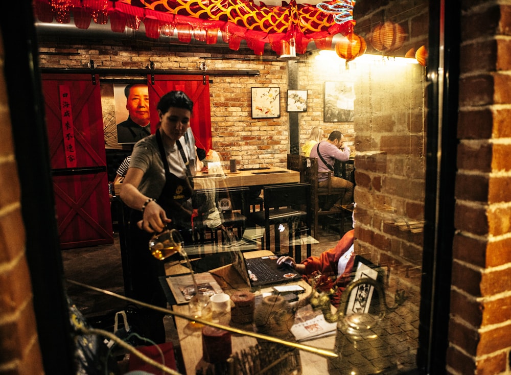 a man pouring a glass of wine in a restaurant