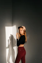 An editorial-style photo of a model posing confidently with natural light casting gentle shadows.