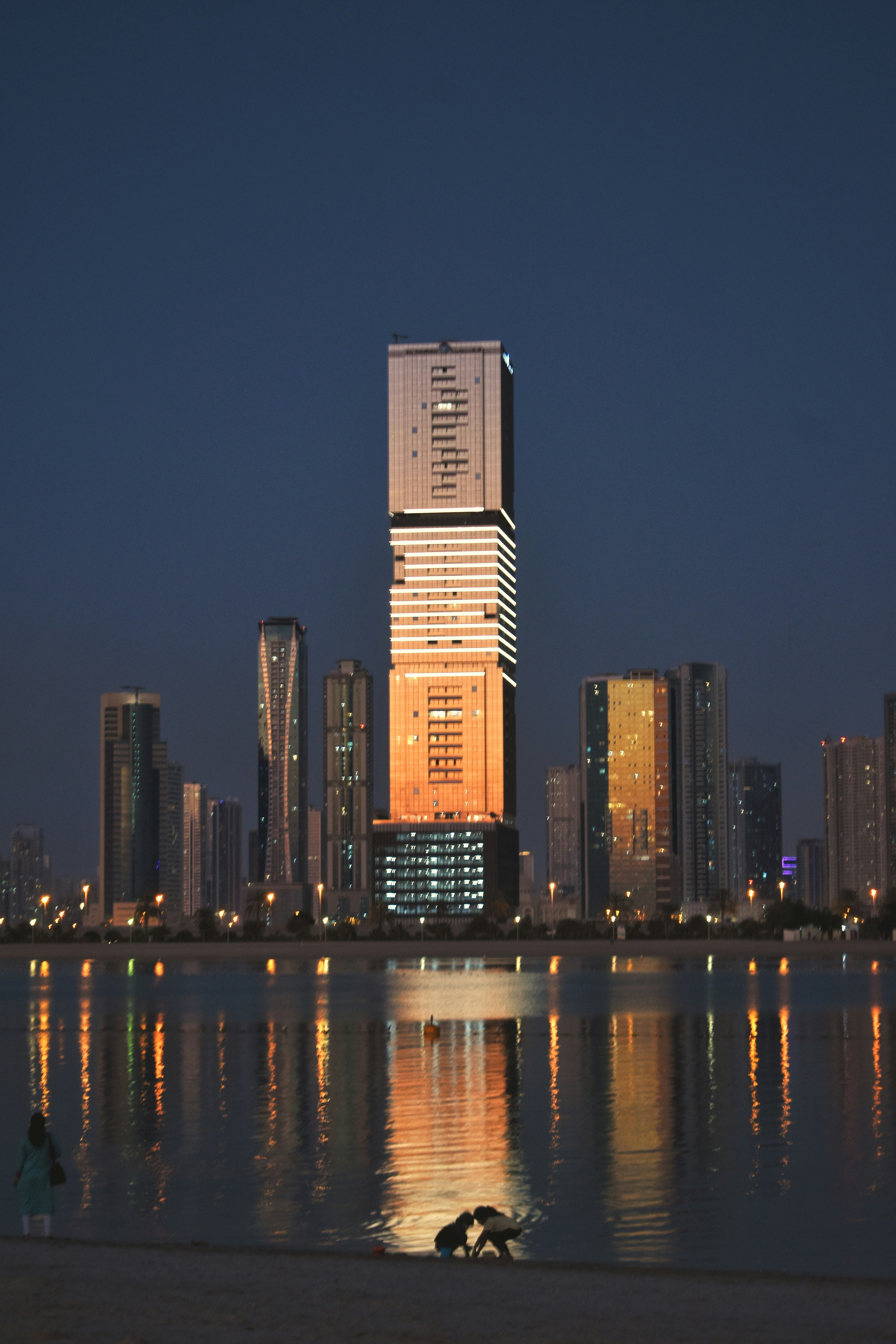 a large body of water with a city in the background