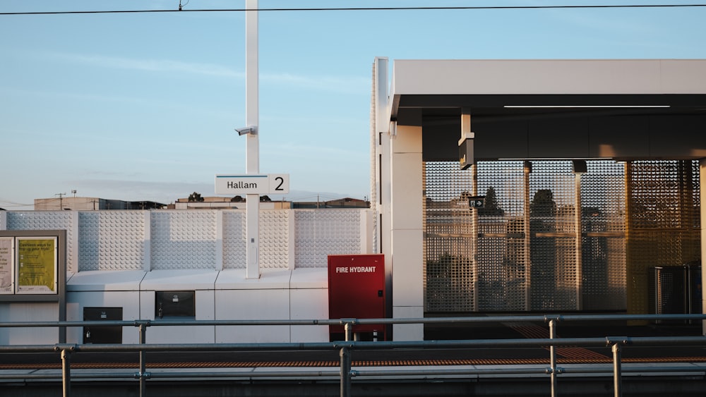 a white building with a red sign in front of it