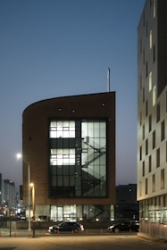 Modern building project overlooking a cityscape at dusk.