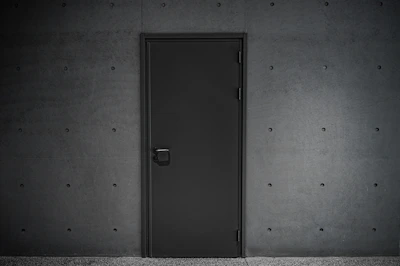 a black door is open in a dark room