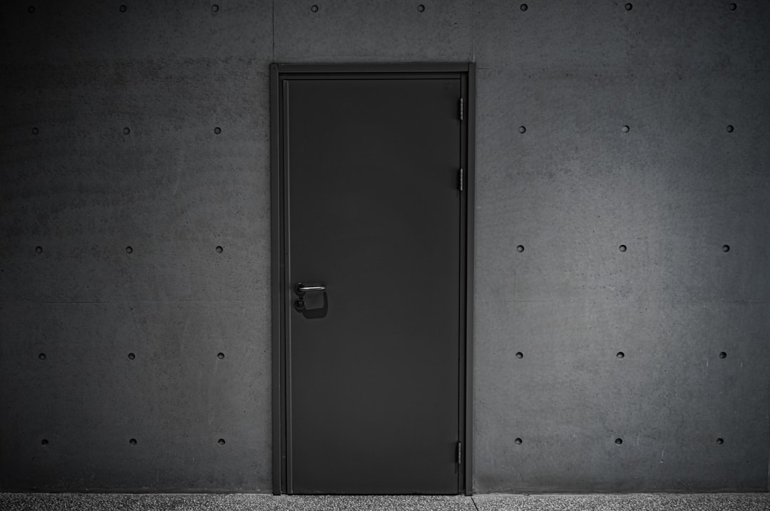 a black door is open in a dark room