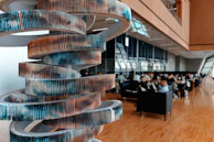 Resin art piece with swirling colors displayed in a luxury office lobby.