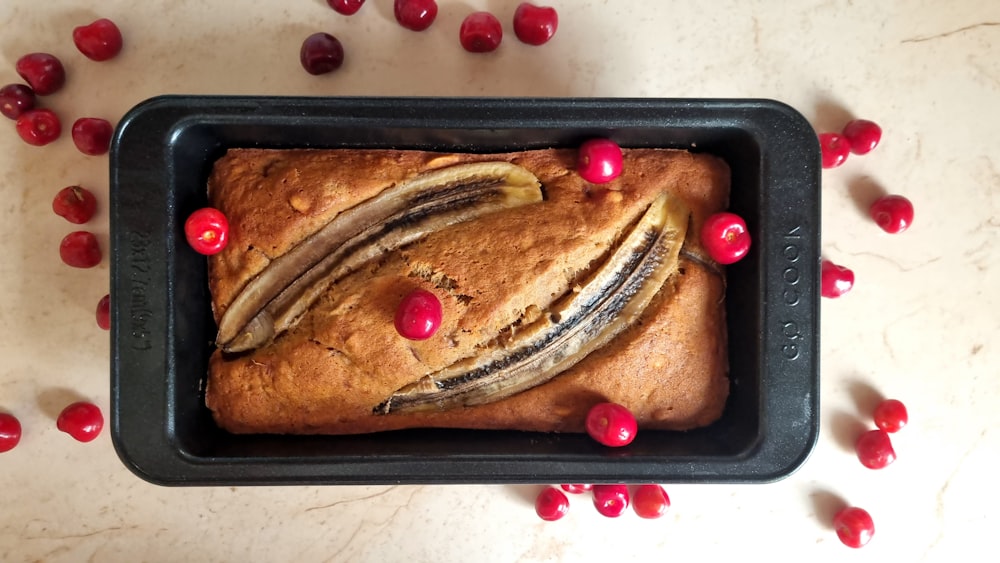 a loaf of bread with fruit on top of it