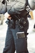a police officer is holding a gun and a helmet