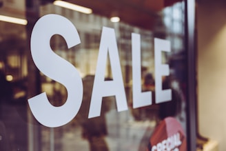 a close up of a sale sign in a store window