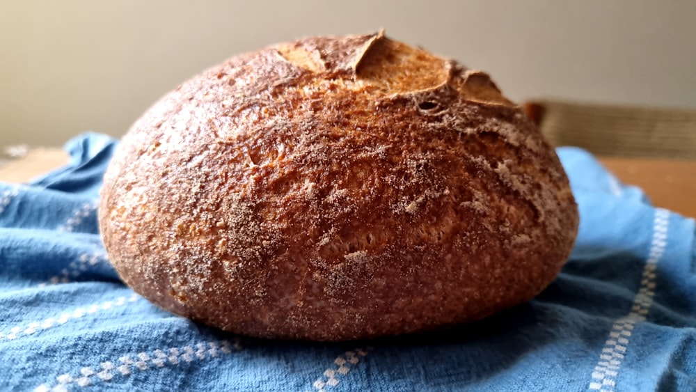 a loaf of bread sitting on top of a blue towel