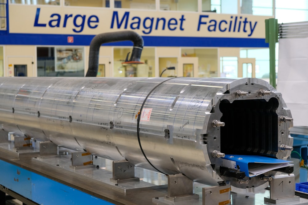 a large metal tube on a machine in a factory