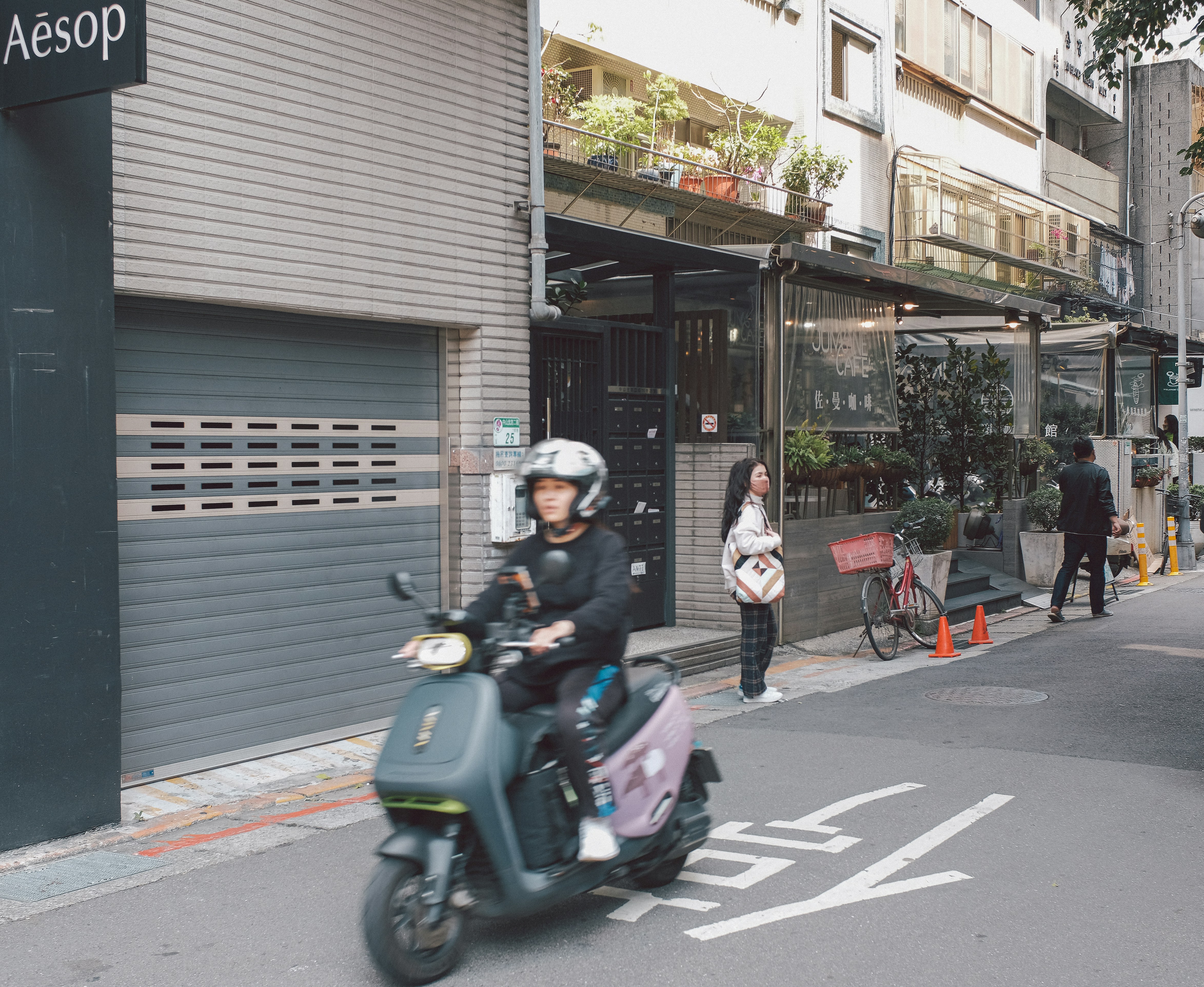 A person riding a scooter on a city street photo – Free Taiwan Image on ...