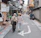 Happy retired couple walking along a colorful coastal town street