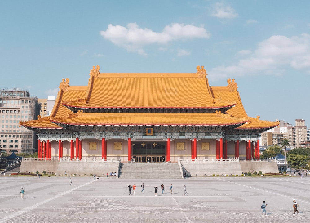 a large building with people walking around it