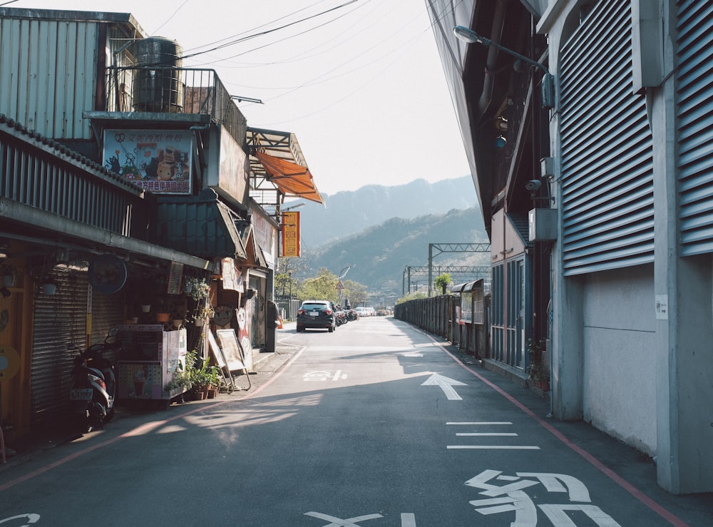 a city street with a car parked on the side of it