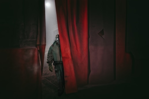 A dramatic scene depicting a scientist in hiding, surrounded by shadows.