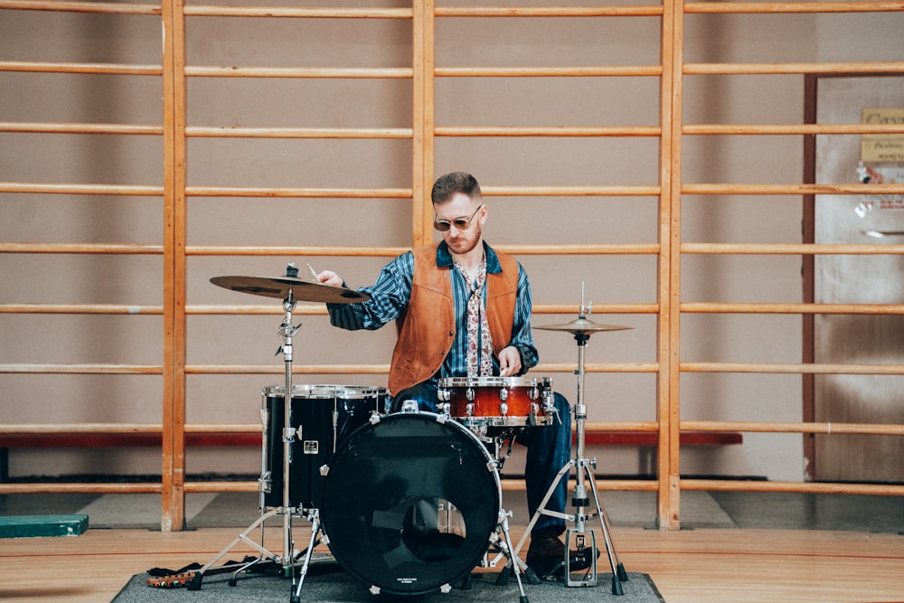 a man is playing drums on a stage