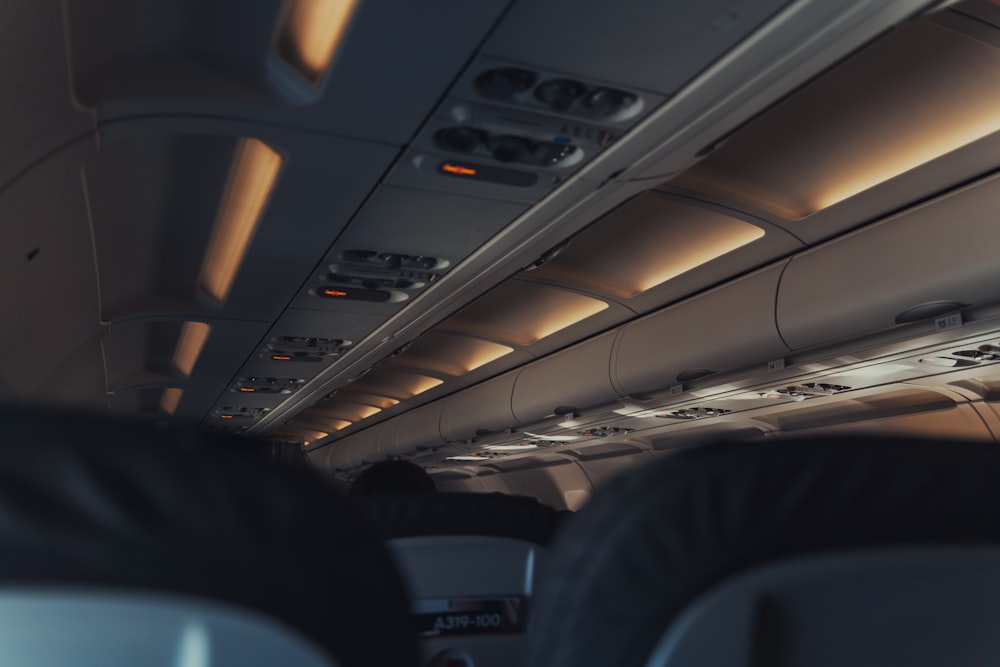 the inside of an airplane with the lights on