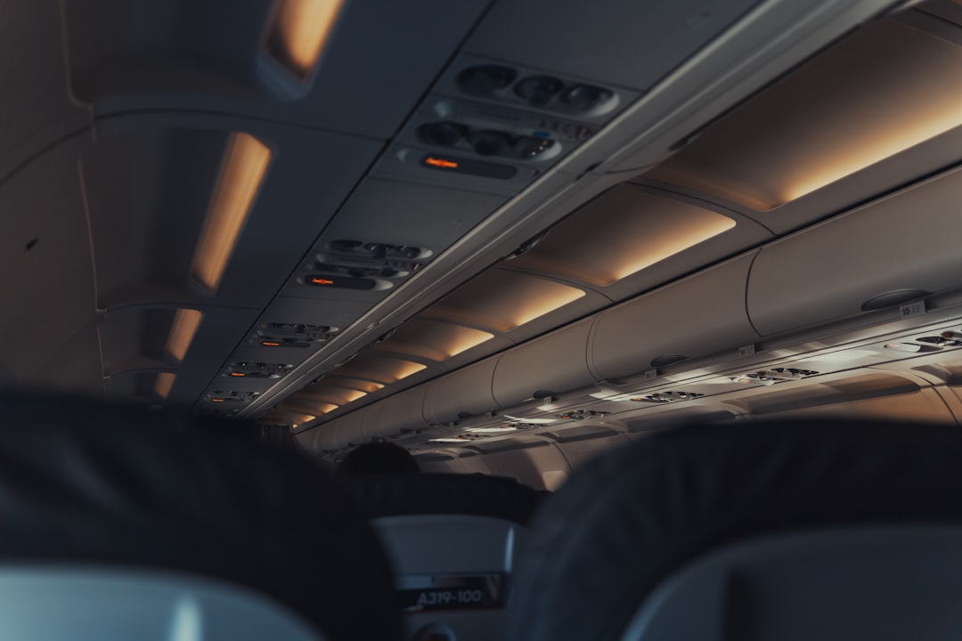 the inside of an airplane with the lights on,