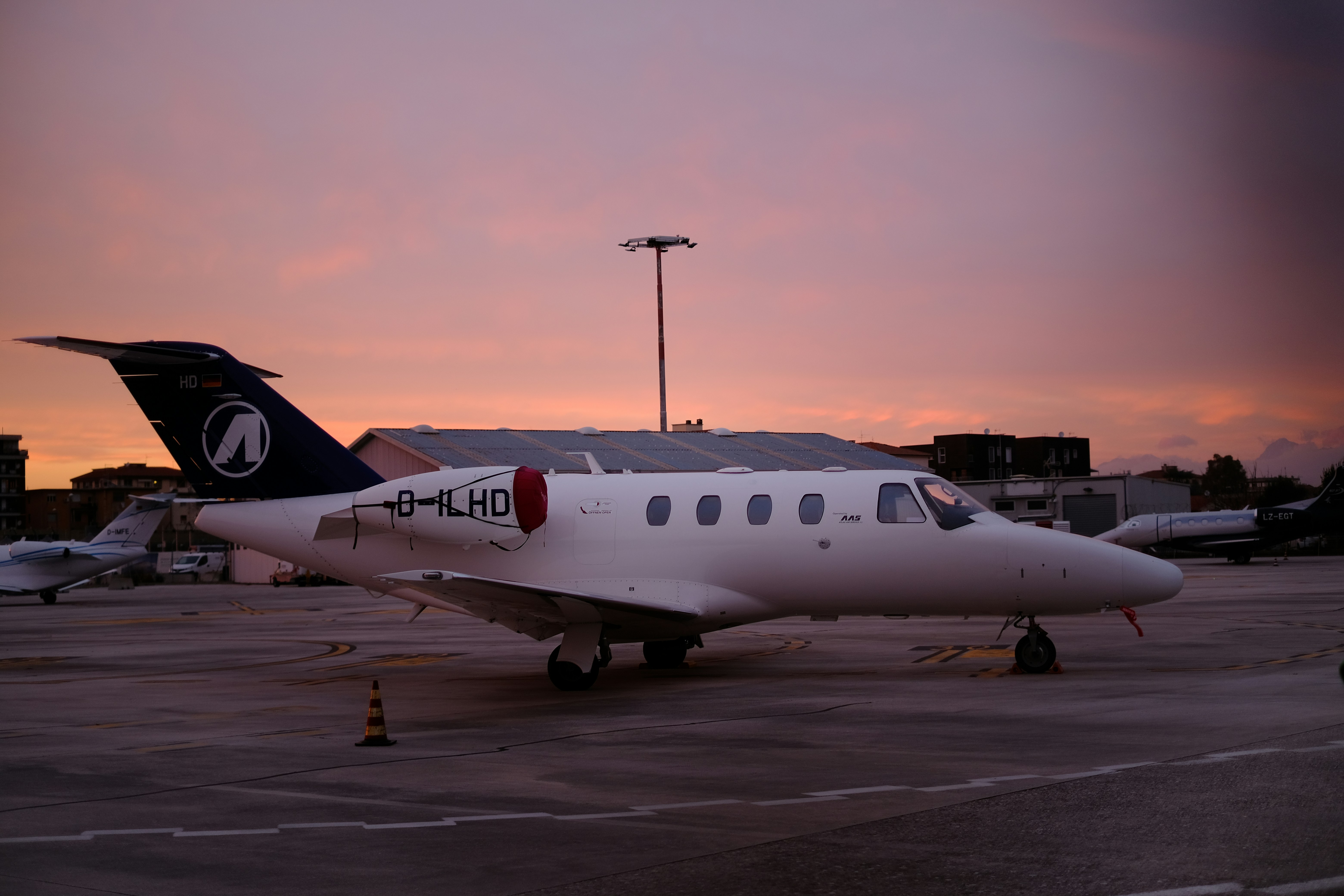 a small white airplane sitting on top of an airport tarmac