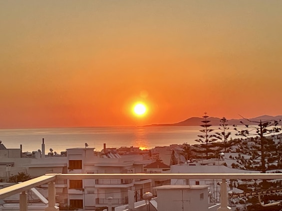 A serene sunset over a peaceful Asian coastal town, symbolizing the promise of a relaxed retirement.