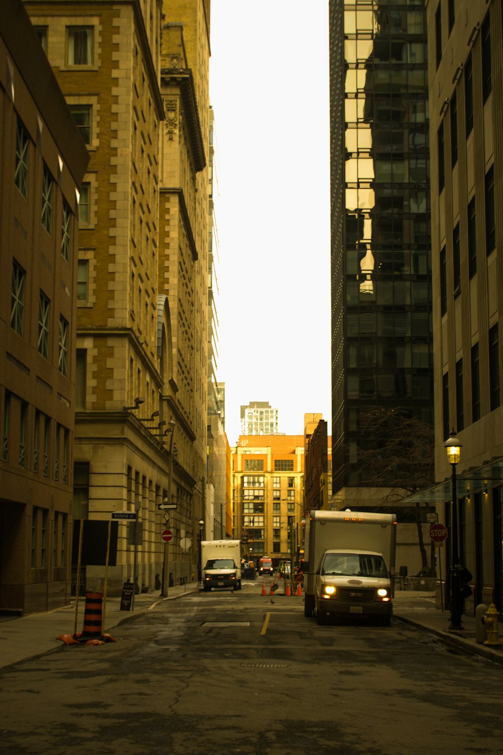 a city street filled with tall buildings next to tall buildings