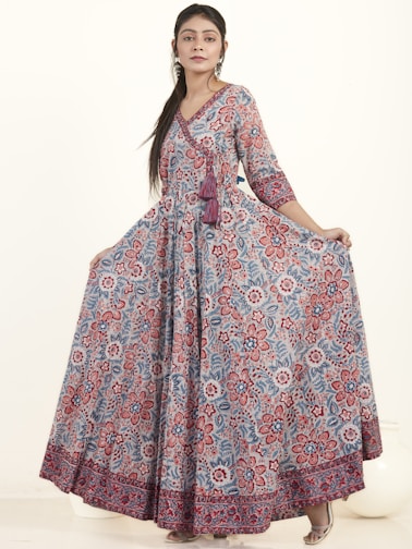 A stylish woman wearing a flowing dress in a vibrant color.