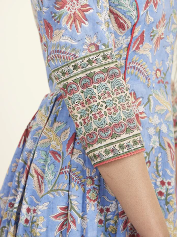 A custom embroidered t-shirt featuring bold, colorful motifs inspired by traditional Indian designs.