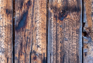 a close up of a wooden wall with peeling paint