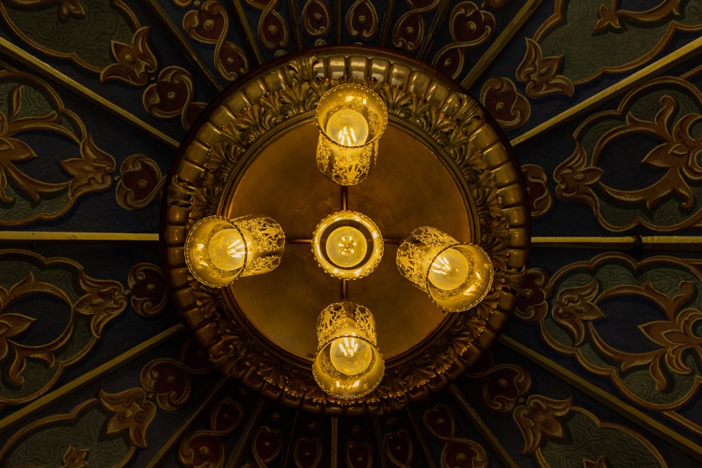 a chandelier with five lights hanging from it