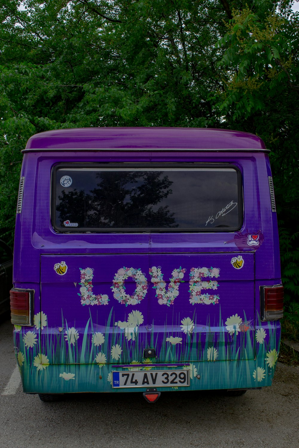 a purple van with flowers painted on it