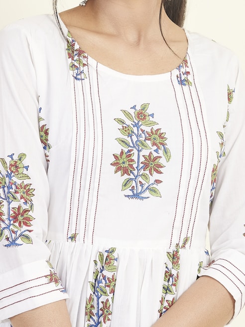 Close-up of embroidered floral patterns on vibrant fabric