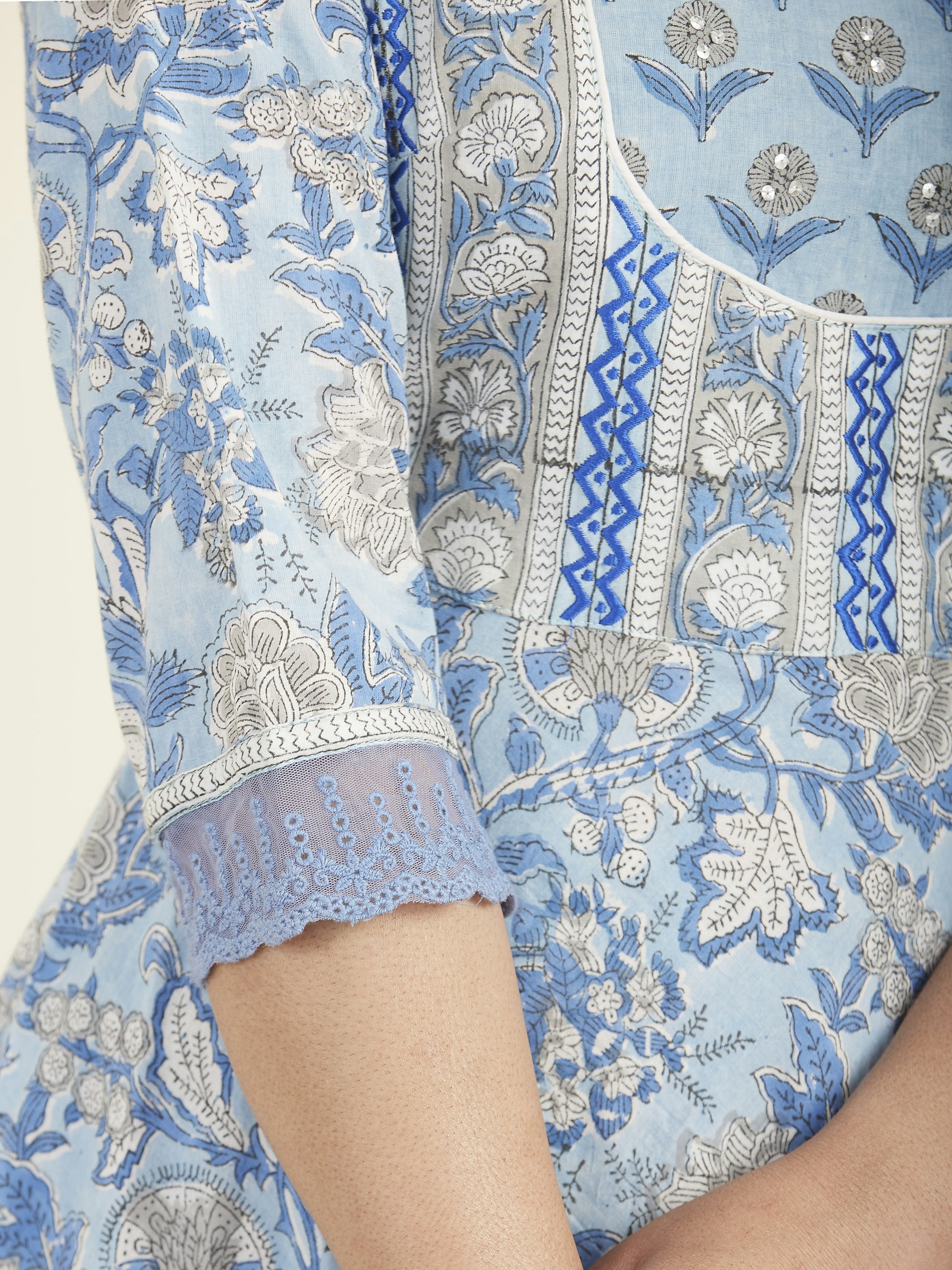 Close-up of delicate fabric textures and elegant details on a chic blouse, highlighting the craftsmanship behind Janina Slopianka's designs.