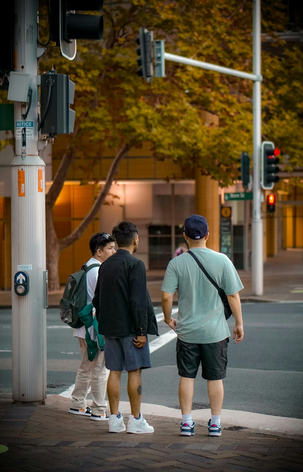 a group of people waiting at a cross walk