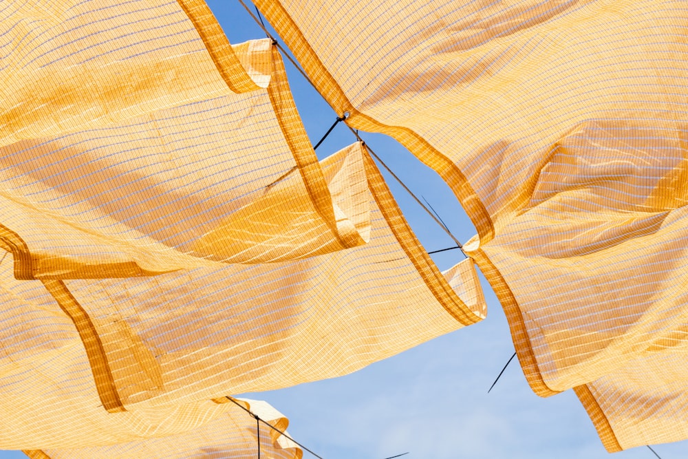 a group of yellow cloths hanging in the air