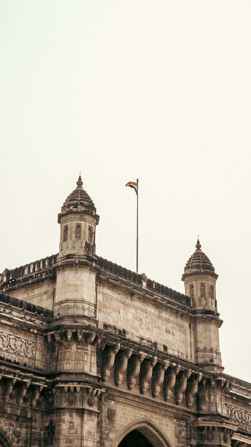 a tall building with a flag on top of it