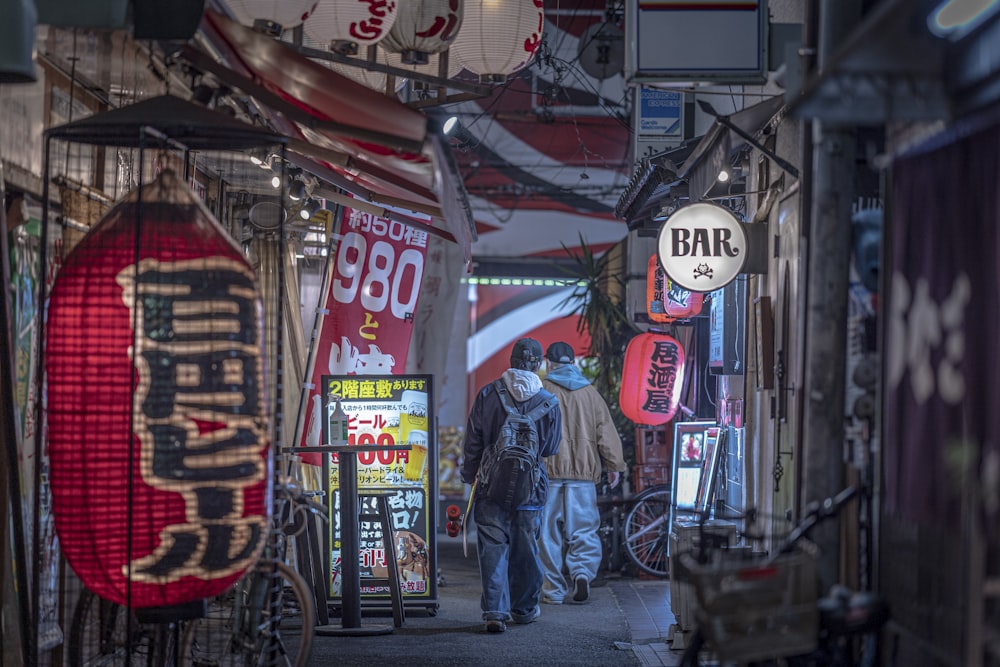 a man walking down a street next to a bar