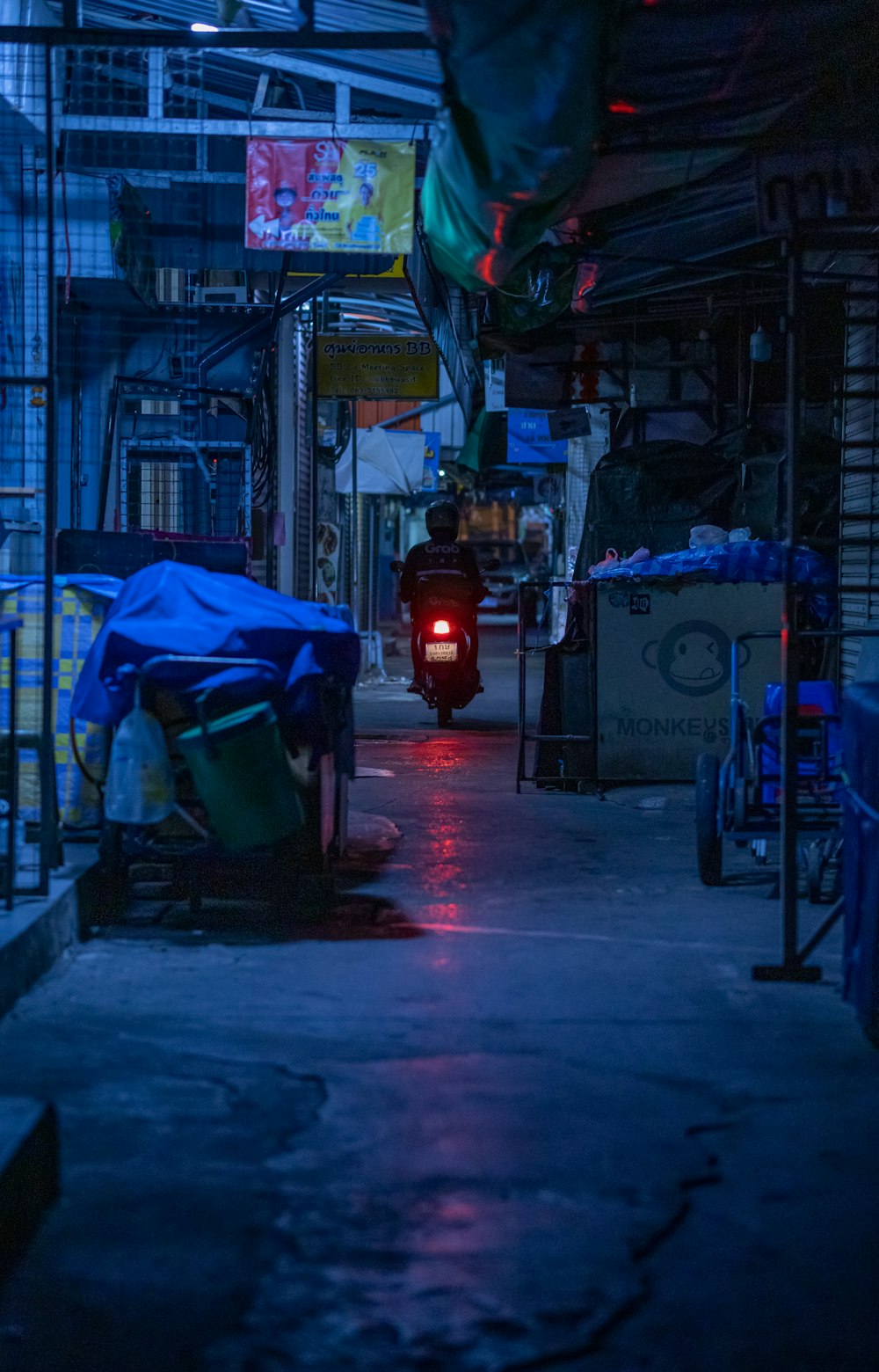 a dark alley with a red light at the end of it