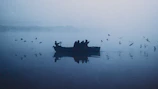An early morning scene with the maréa azul boat cutting through misty waters under a soft pink sky.
