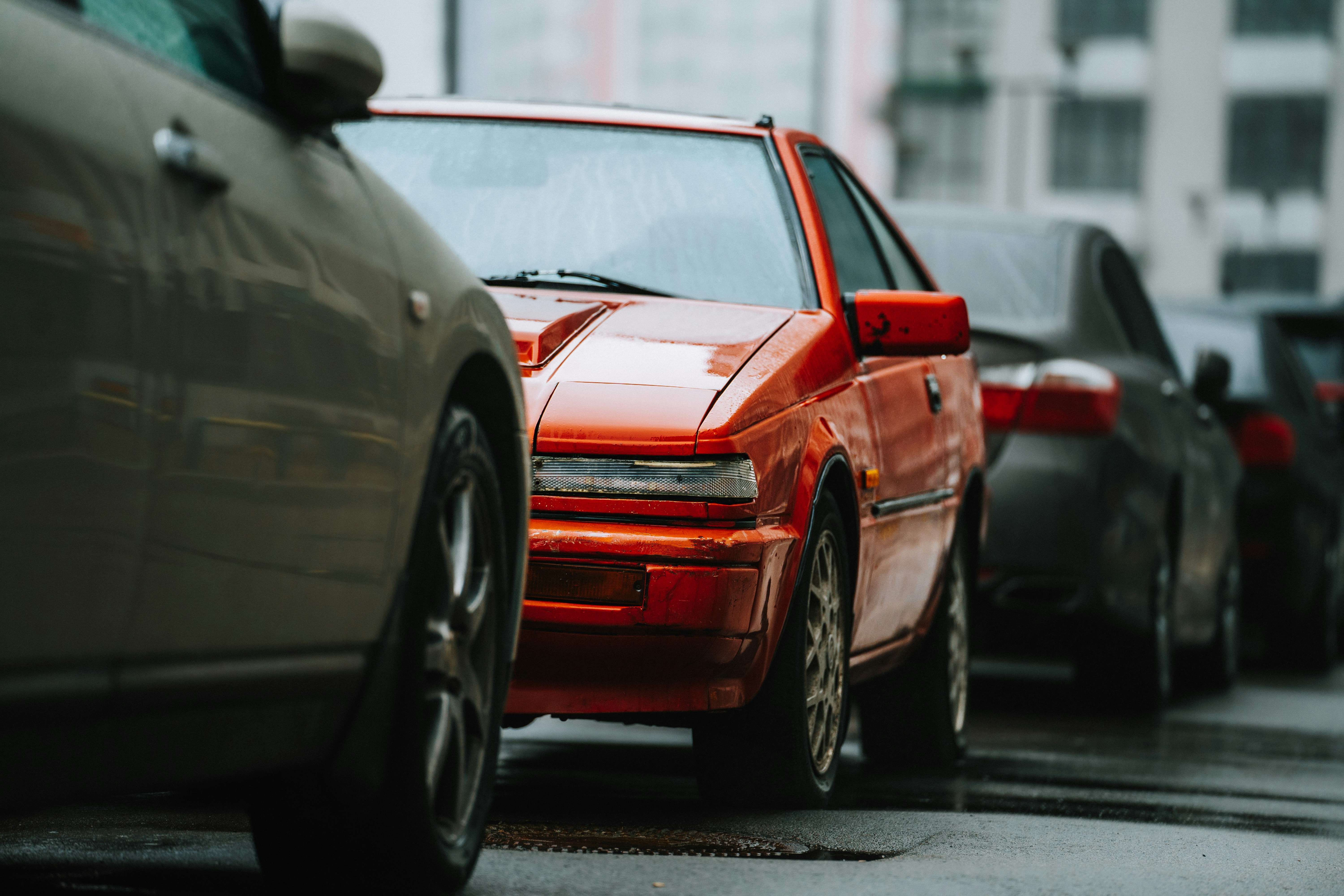 a row of parked cars on a city street