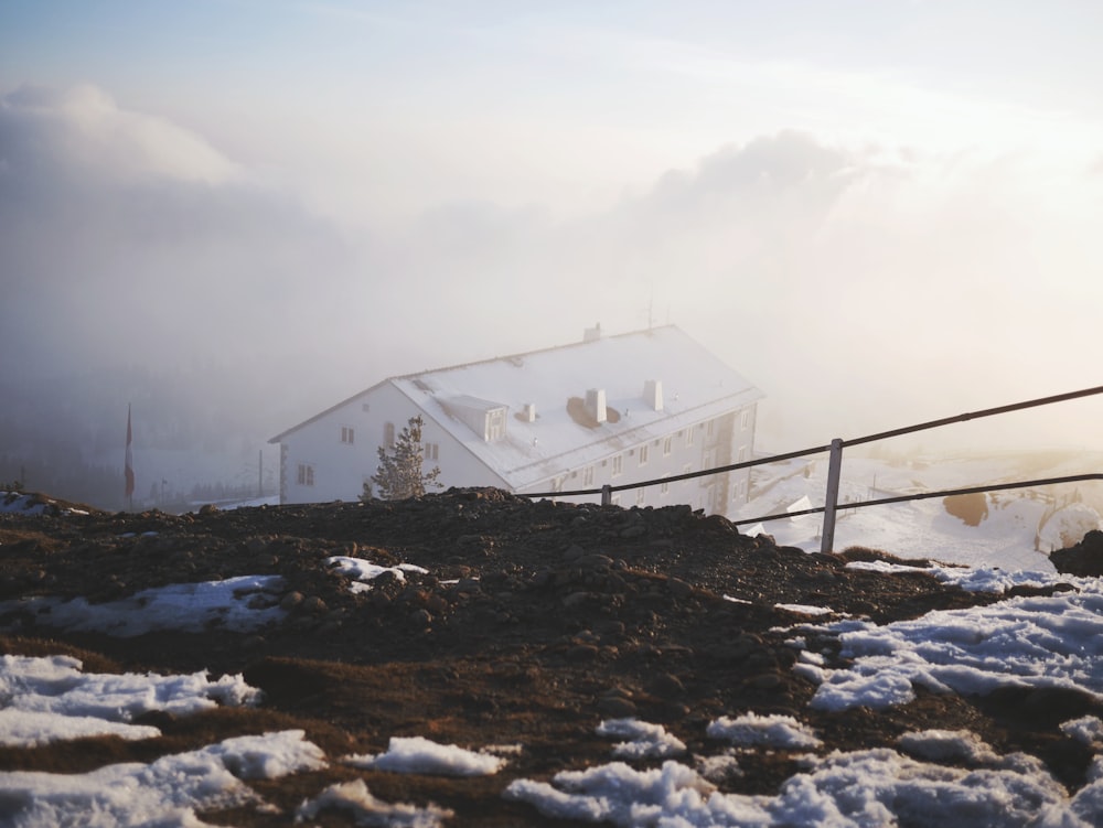 a house on top of a hill covered in snow