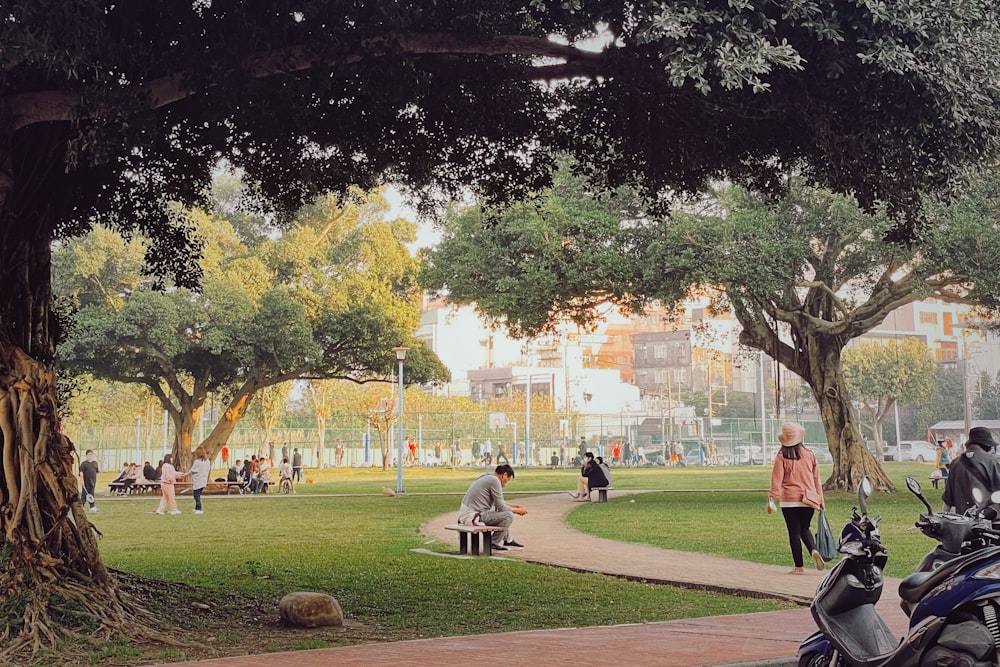 a group of people walking around a park