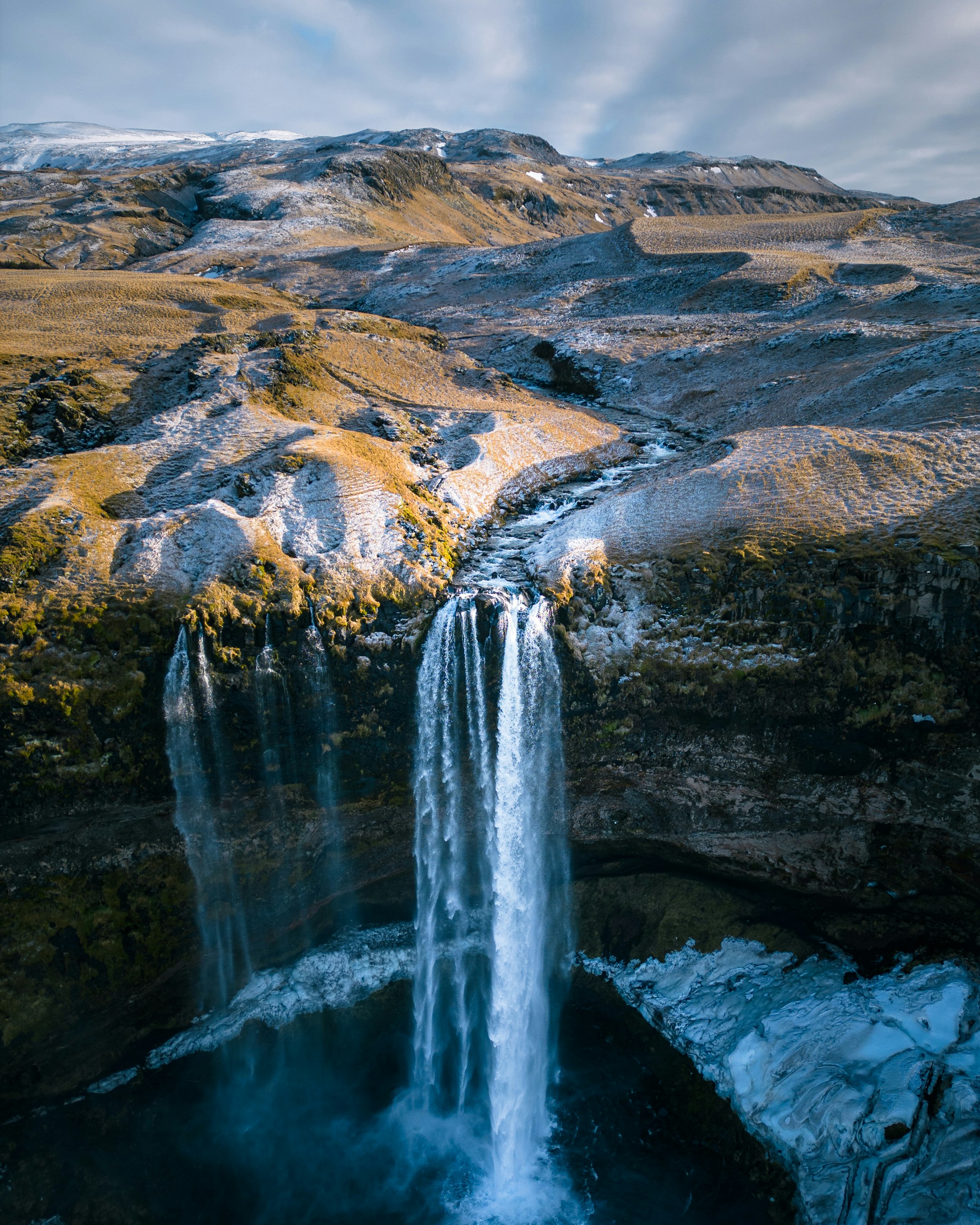 a waterfall in the middle of a mountain