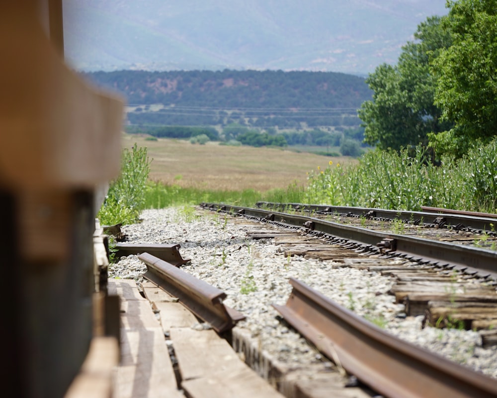 a train track with a mountain in the background