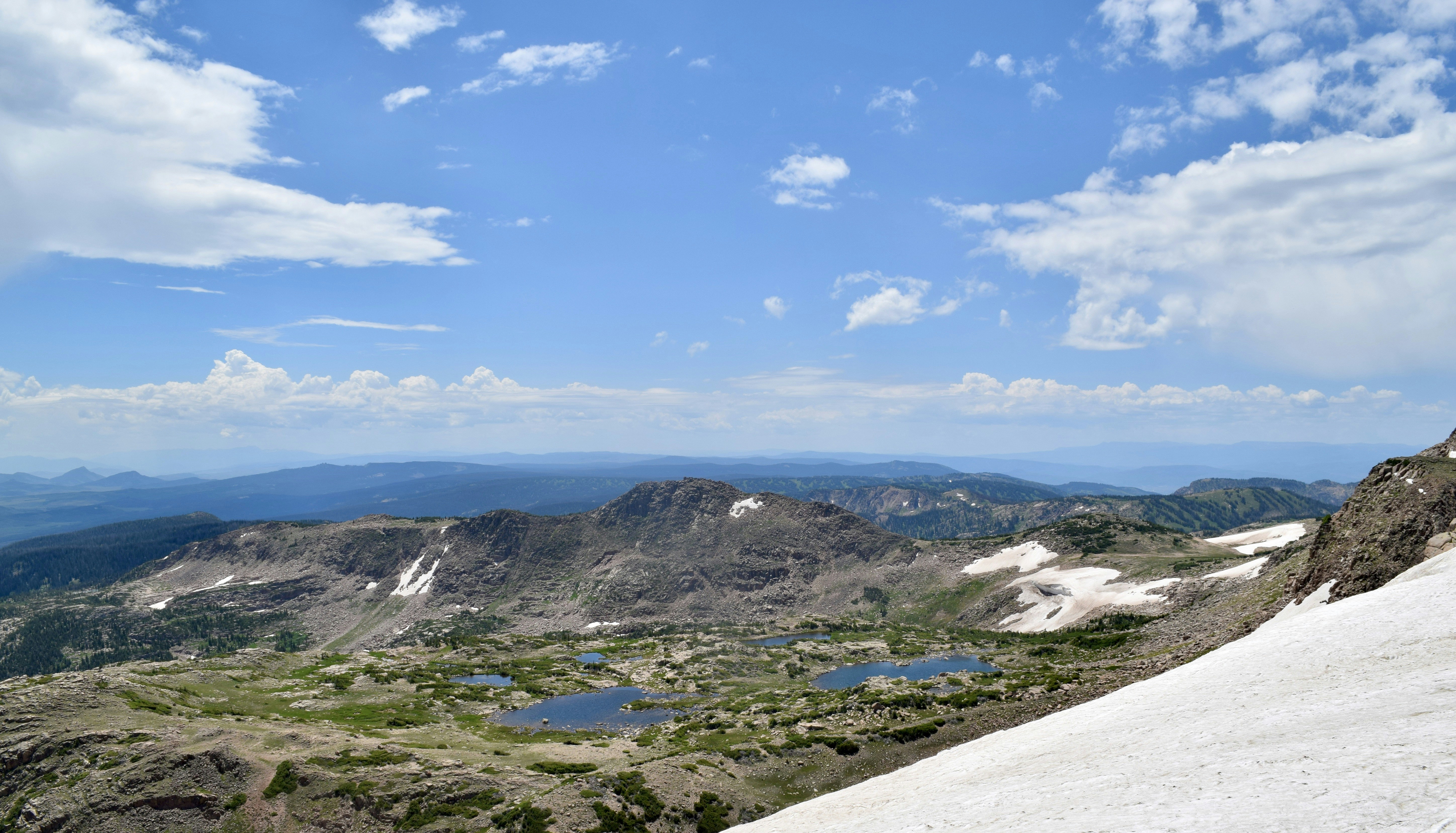 a man standing on top of a snow covered mountain