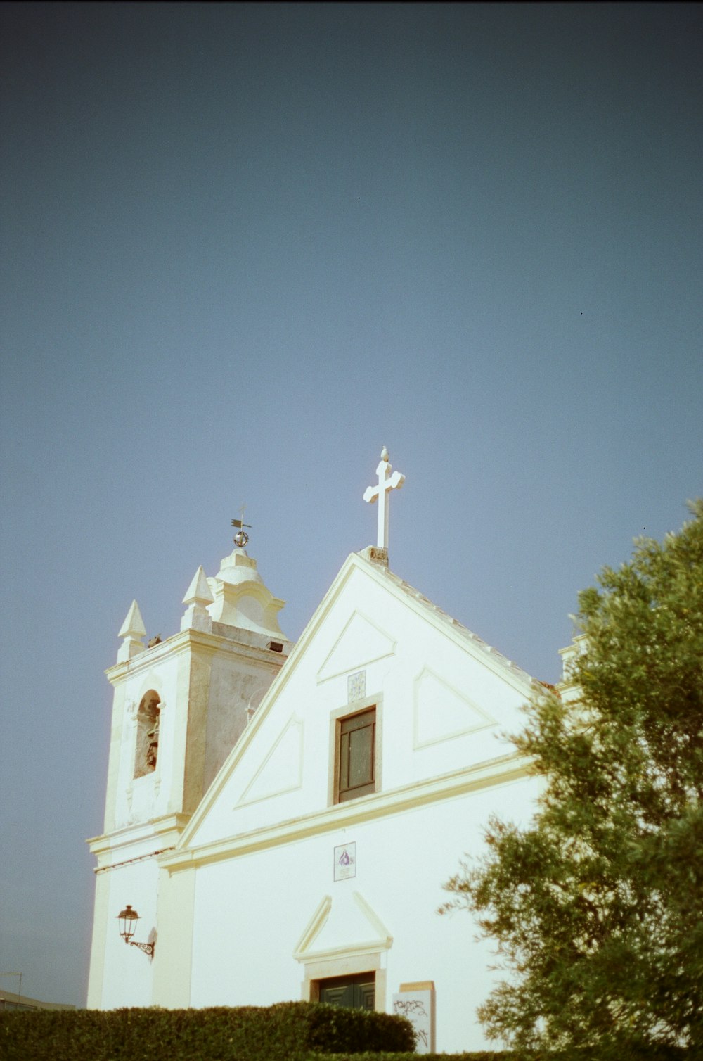 a church with a steeple and a cross on top