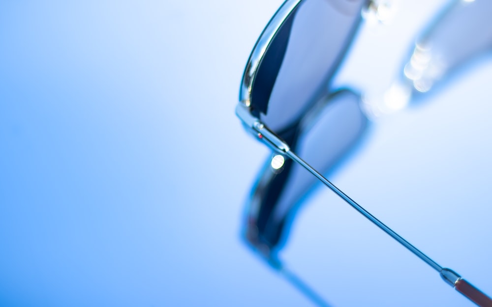 the reflection of a pair of sunglasses on a blue background