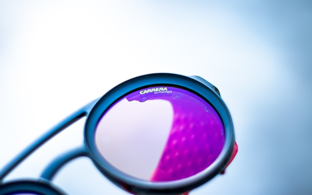 a close up of a magnifying glass with a purple object in it