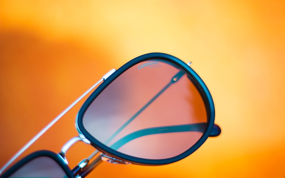 a pair of glasses with a reflection of the sun